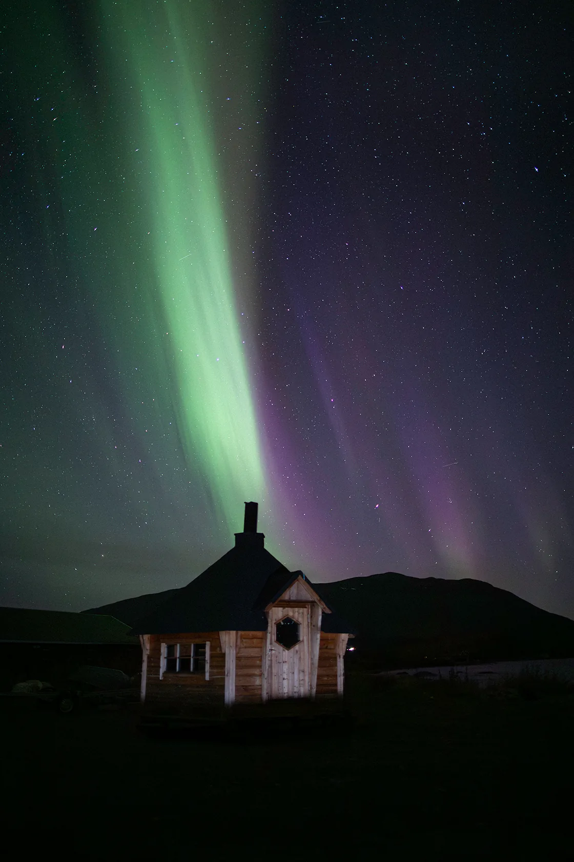 Northern lights over a snow-covered chapel outside Kiruna