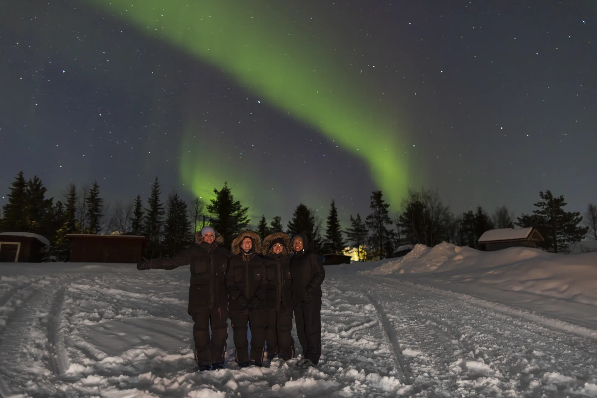 Northern lights over a snow-covered Kiruna landscape