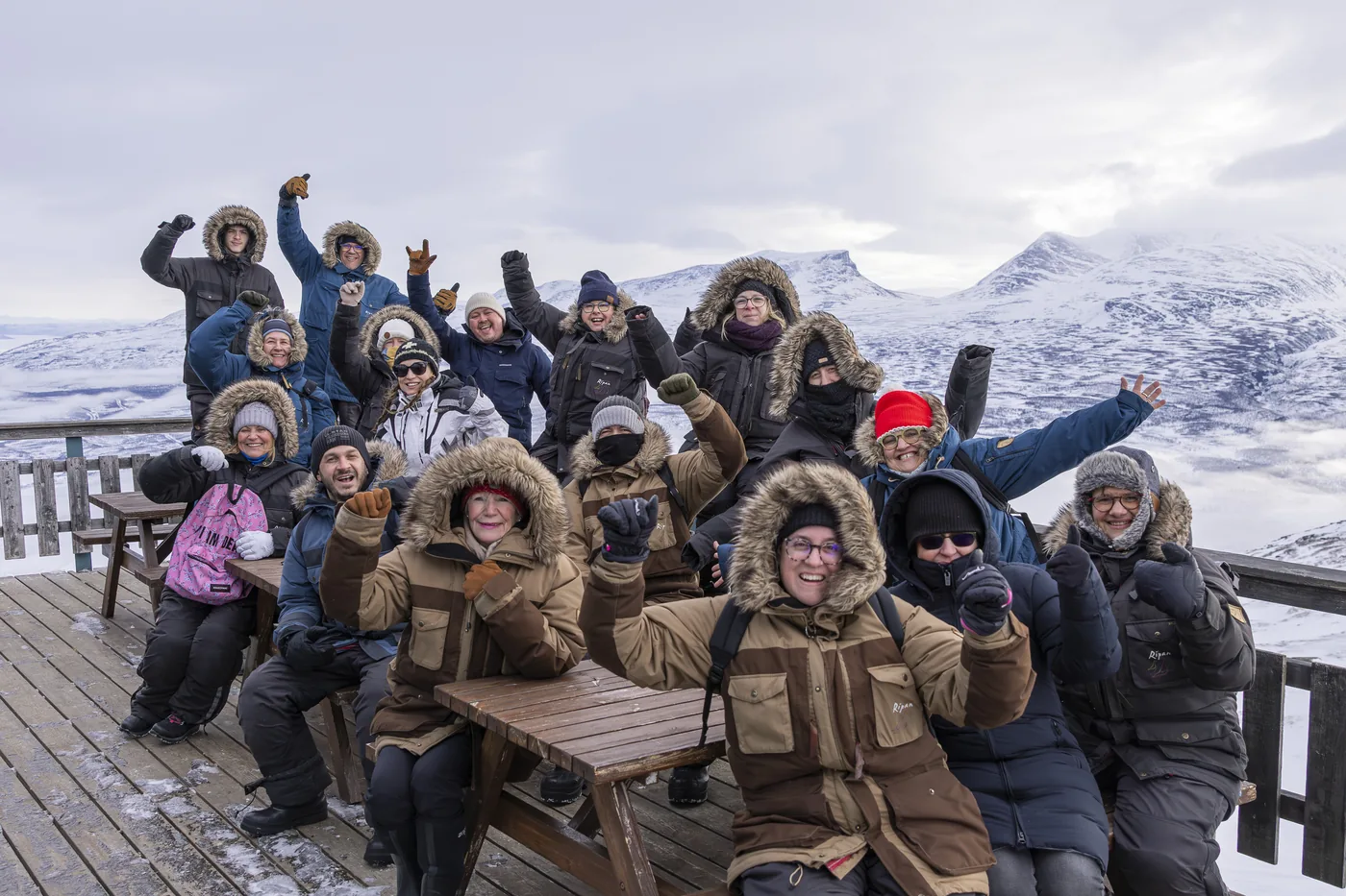 Guests relaxing together on a snowy terrace in Kiruna