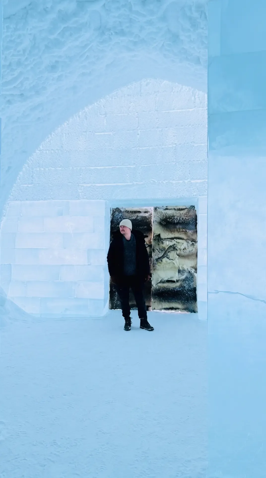Guest standing in the vast carved ice hall inside ICEHOTEL 365