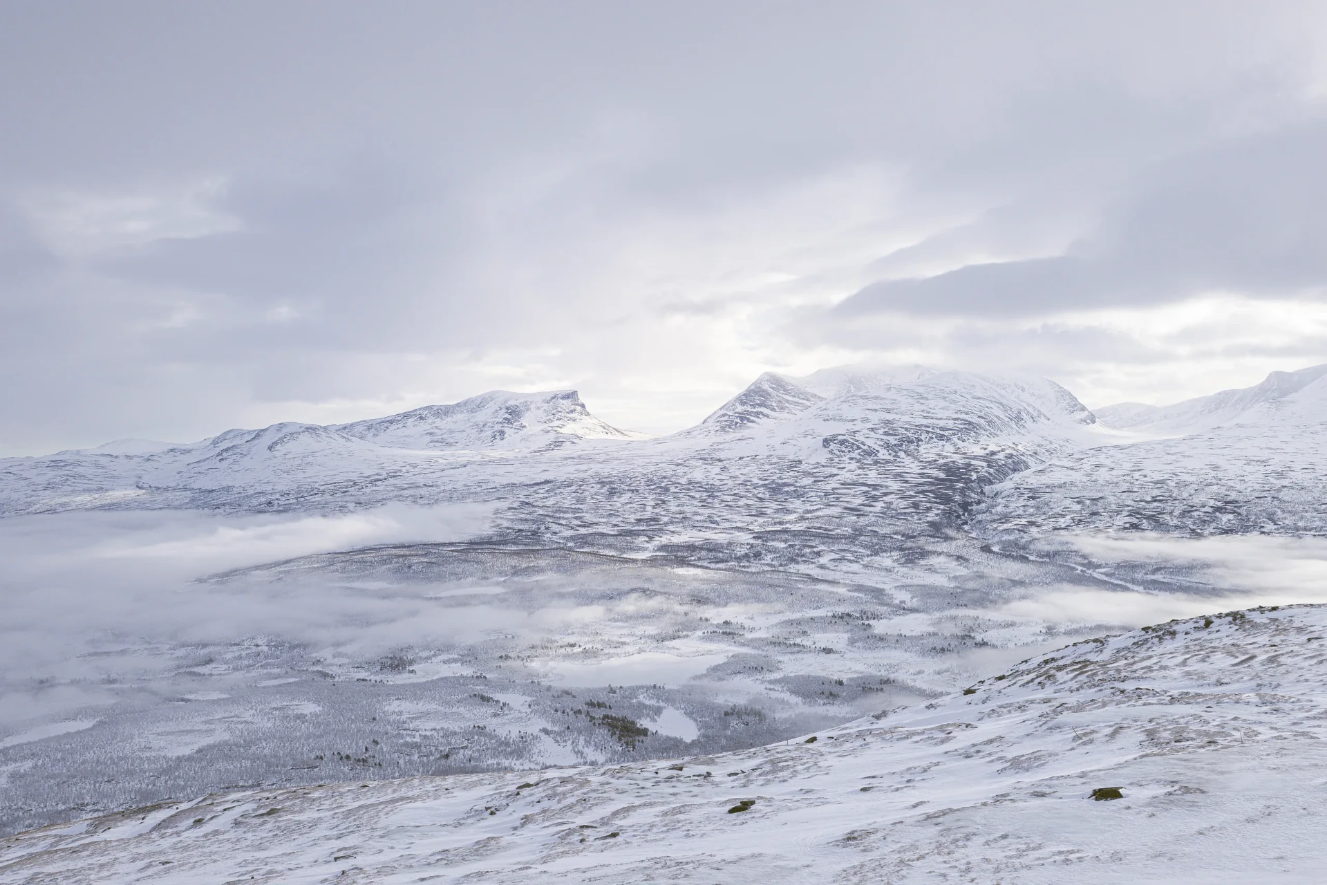 Wide mountain vista in Swedish Lapland under low winter light