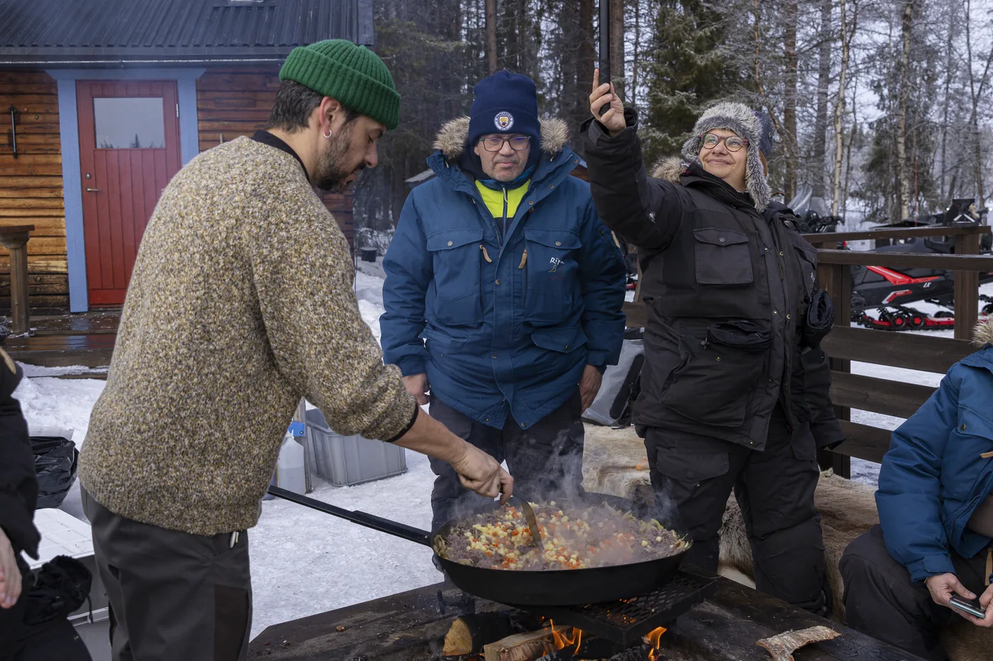 Hot lunch cooked over an open fire during the snowmobile and ice fishing day