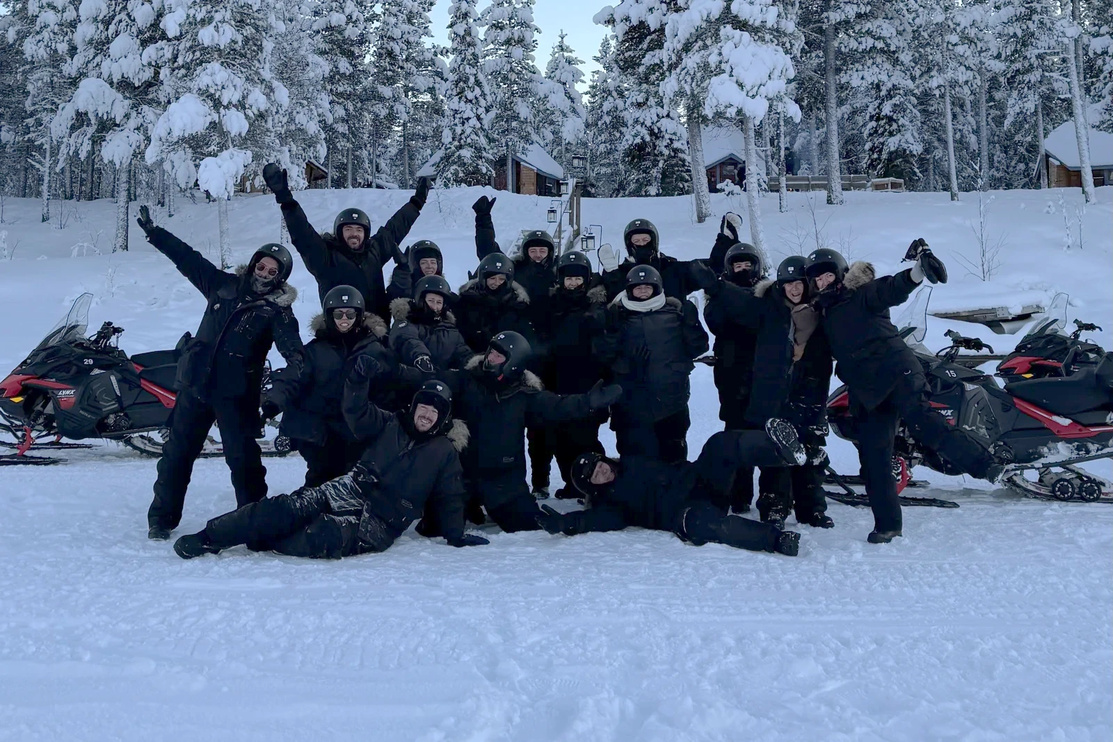 Our guest group celebrating beside the snowmobiles in the forest outside Kiruna